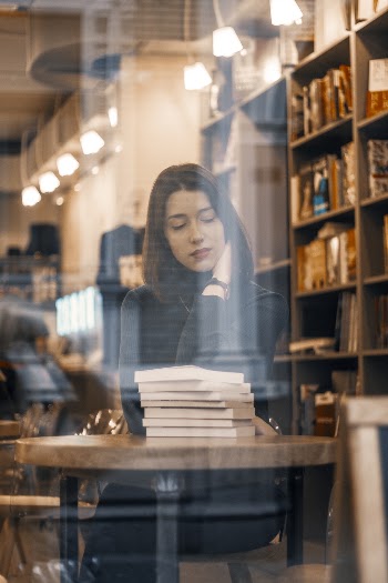 Photo Of Woman Leaning On Wooden Table