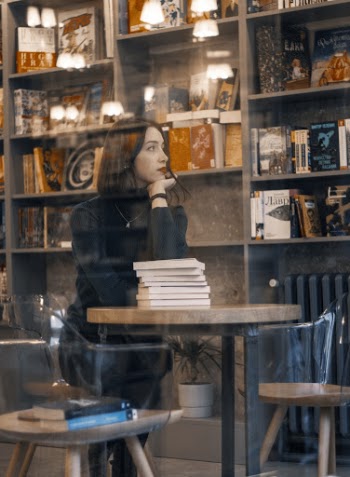 Photo Of Woman Leaning On Wooden Table