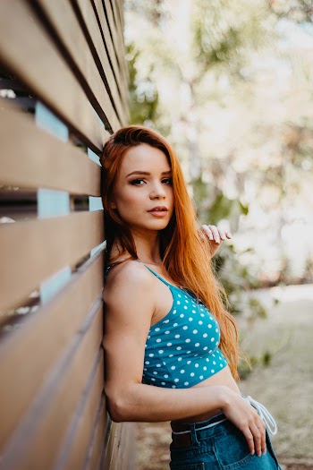Photo Of Woman Leaning On Wooden Wall