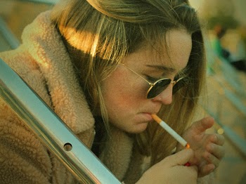 Photo of Woman Lighting Up A Cigarette