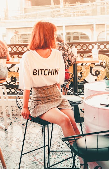 Photo of Woman Looking Away Sitting on Bar Stool