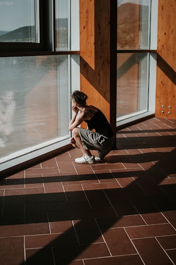 Photo of Woman Looking Through Window