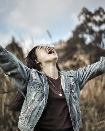 Photo Of Woman Looking Up With Arms Wide Open 