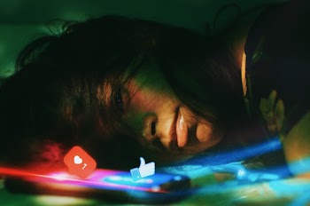Photo Of Woman Lying Beside A Phone