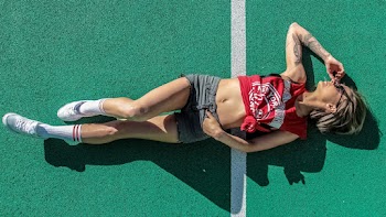 Photo of Woman Lying Down on Green Surface