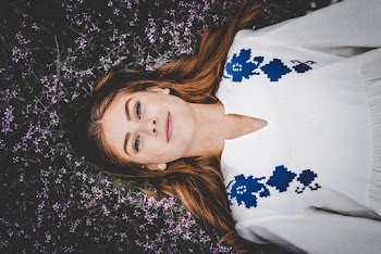 Photo of Woman Lying on Flowes
