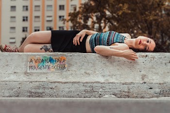 Photo of Woman Lying on Gray Concrete Block
