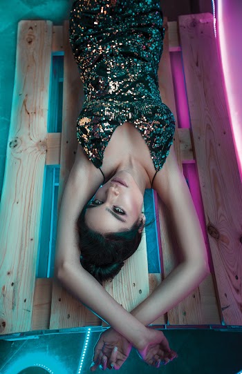 Photo of Woman Lying on Wooden Crate
