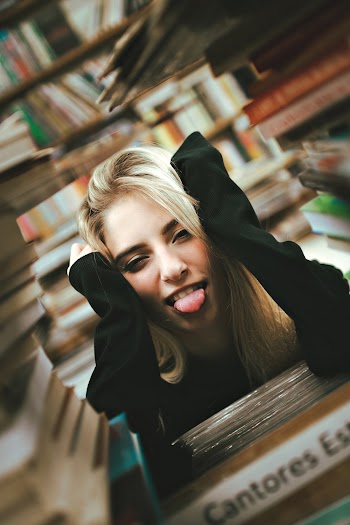 Photo of Woman Near Books