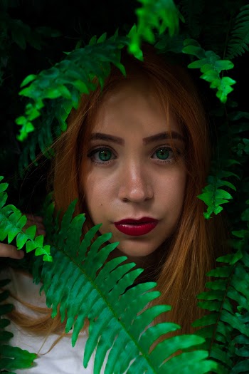 Photo of Woman Near Fern Plants