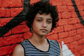 Photo of Woman Near Red Wall