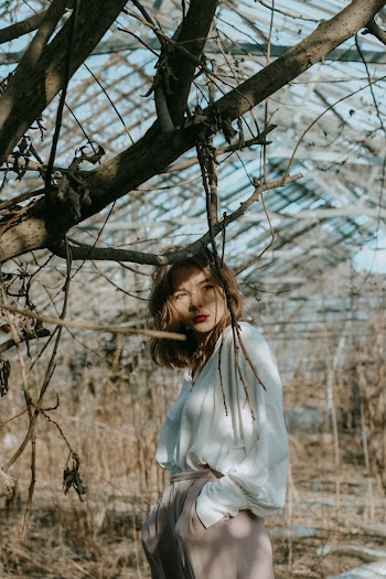 Photo of Woman Near Tree Branches