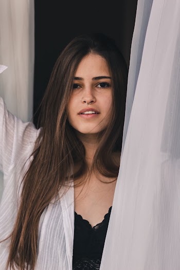 Photo of Woman Near White Curtain