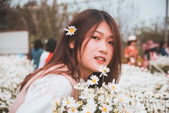 Photo of Woman Near White Flowers