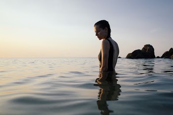 photo of woman on sea during daytime