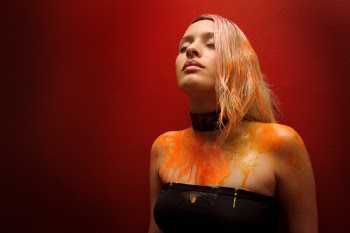 Photo of Woman Orange Paint on Body