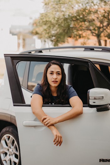 Photo of Woman Peeking Out on Car Window