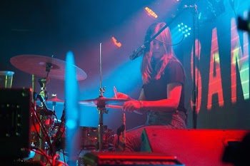 photo of woman playing drums