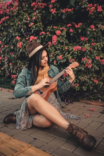 Photo of Woman Playing Ukelele On Pavement
