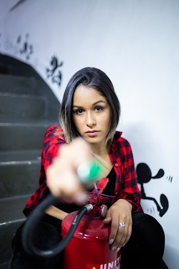Photo of Woman Pointing the Fire Extinguisher Nozzle