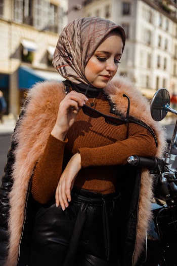 Photo of Woman Posing by Motorcycle