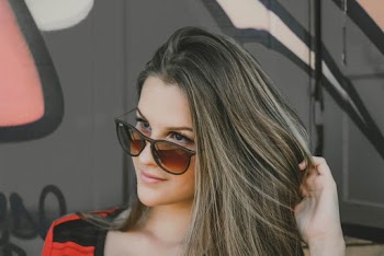 Photo of Woman Posing in Sunglasses Looking Away