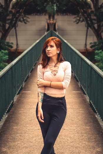Photo of Woman Posing in the Middle of a Bridge