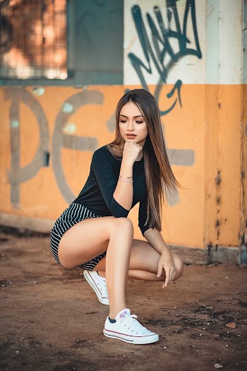 Photo of Woman Posing Near Wall