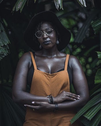 Photo of Woman Posing With Green-leafed Plants in the Background