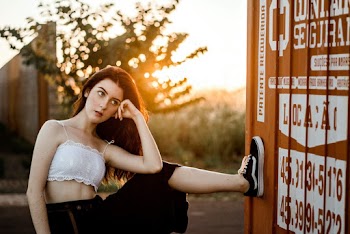 Photo of Woman Posing With Her Left Leg on Wall 