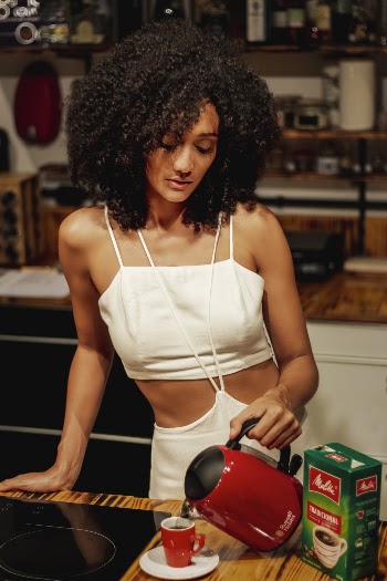 Photo of Woman Pouring Hot Water on Cup