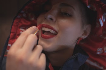 Photo of Woman Putting Red Lipstick