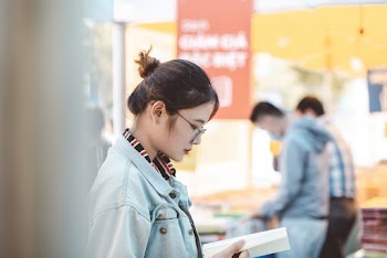 Photo of Woman Reading Book