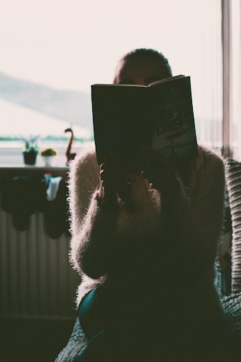 Photo of Woman Reading Book