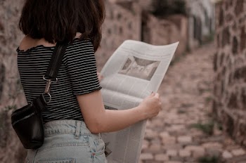 Photo Of Woman Reading Newspaper