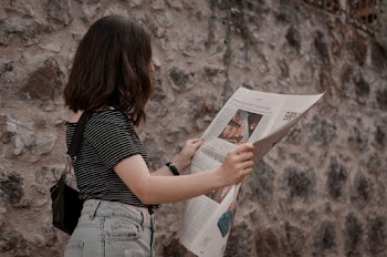 Photo Of Woman Reading Newspaper