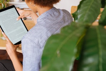 Photo Of Woman Reading On Tablet