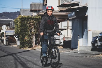 Photo of Woman Riding on Bicycle on Street