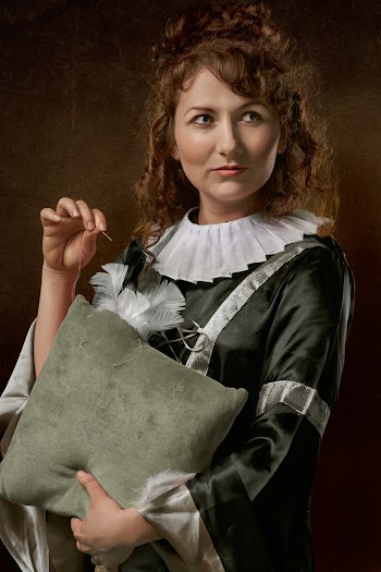 Photo of Woman Ripped Holding Throw Pillow in One Hand and Needle with Thread in the Other