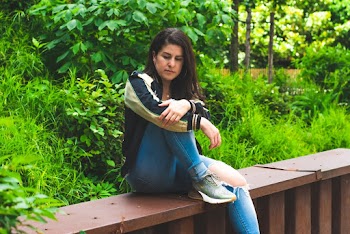 Photo of Woman Sitting Alone Brown Bench Thinking