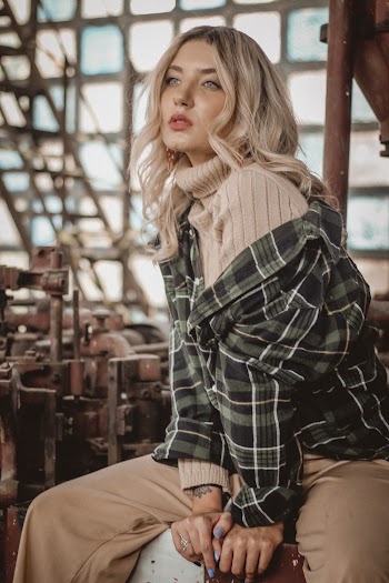 Photo of Woman Sitting Alone Posing While Looking Away