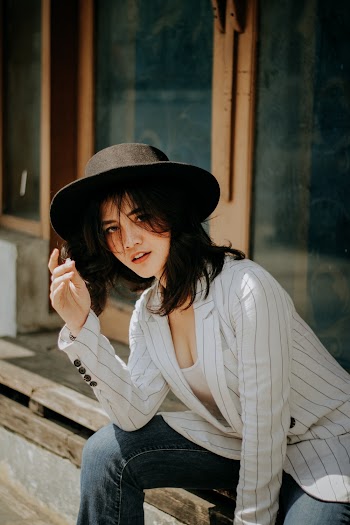 Photo Of Woman Sitting Beside Closed Door
