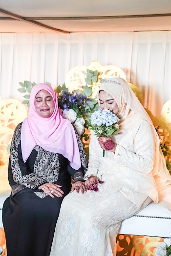 Photo Of Woman Sitting Beside Each Other