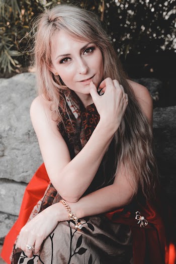 Photo Of Woman Sitting Beside Plant