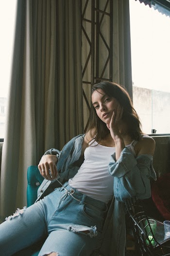 Photo Of Woman Sitting Beside the Window