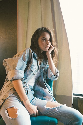 Photo Of Woman Sitting Beside The Window
