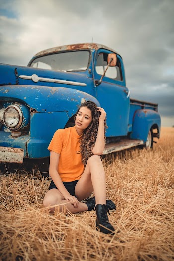 Photo Of Woman Sitting Beside Truck