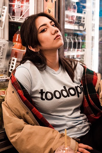 Photo Of Woman Sitting Beside Vendo Machine
