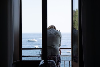 Photo Of Woman Sitting In Terrace