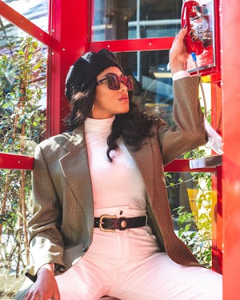 Photo Of Woman Sitting Inside Red Telephone Booth